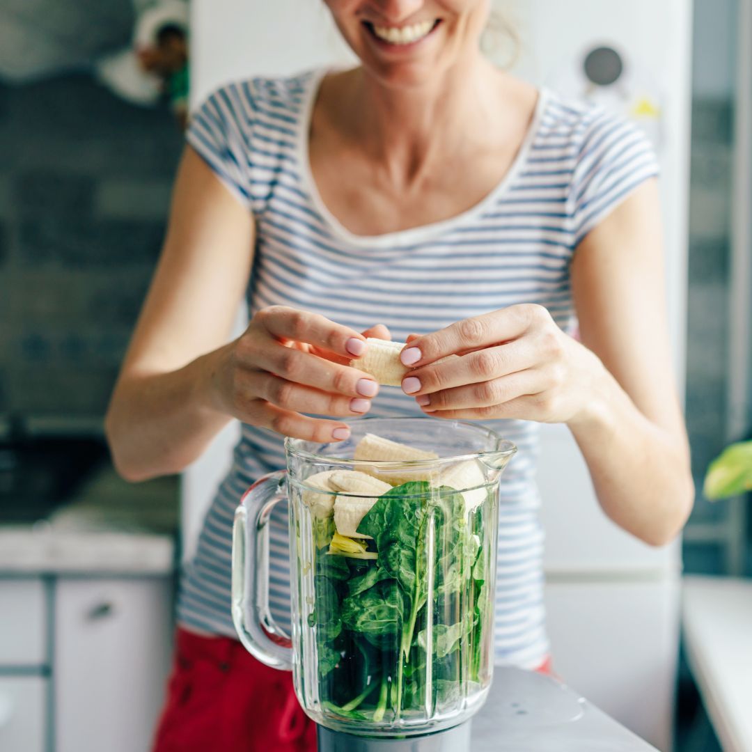 woman preparing a fresh smoothie