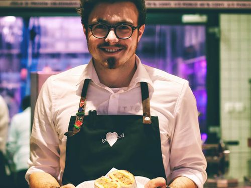 Smiling restaurant worker welcomes customers