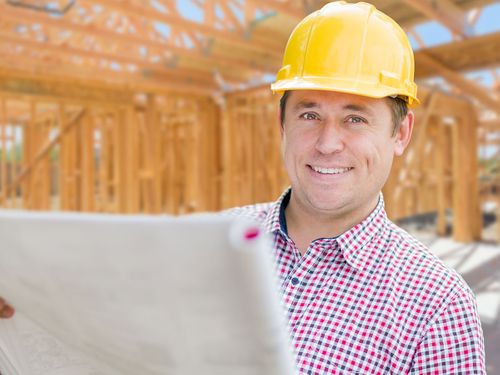 Someone holding construction plans waiting to start the project.