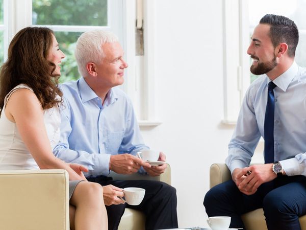 financial advisor with couple planning for retirement