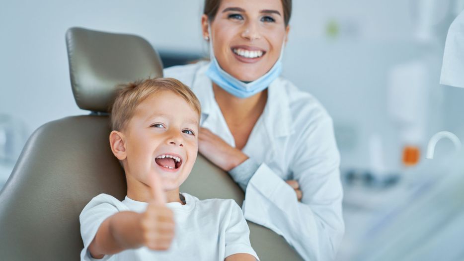 child smiling at dentist