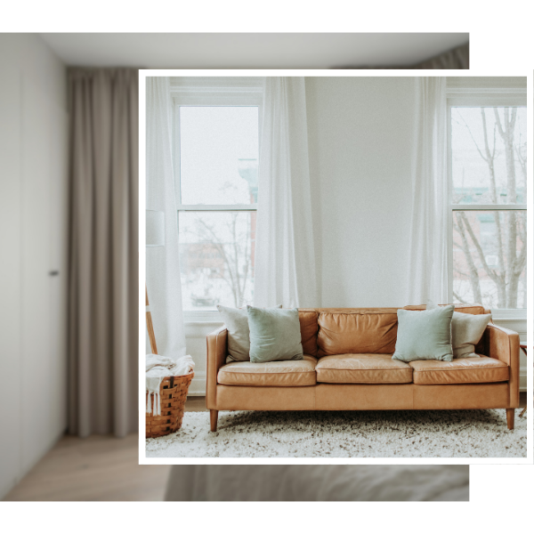 brown leather couch with white curtains behind it
