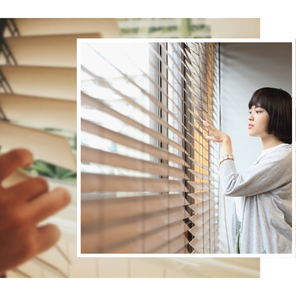 woman looking out of window through custom blinds