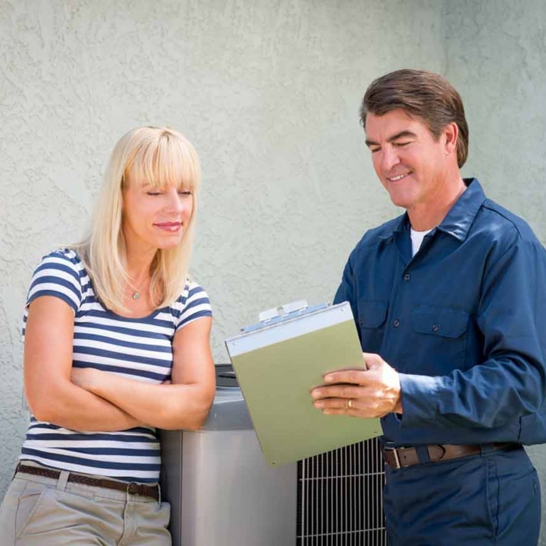 technician talking to happy homeowner 