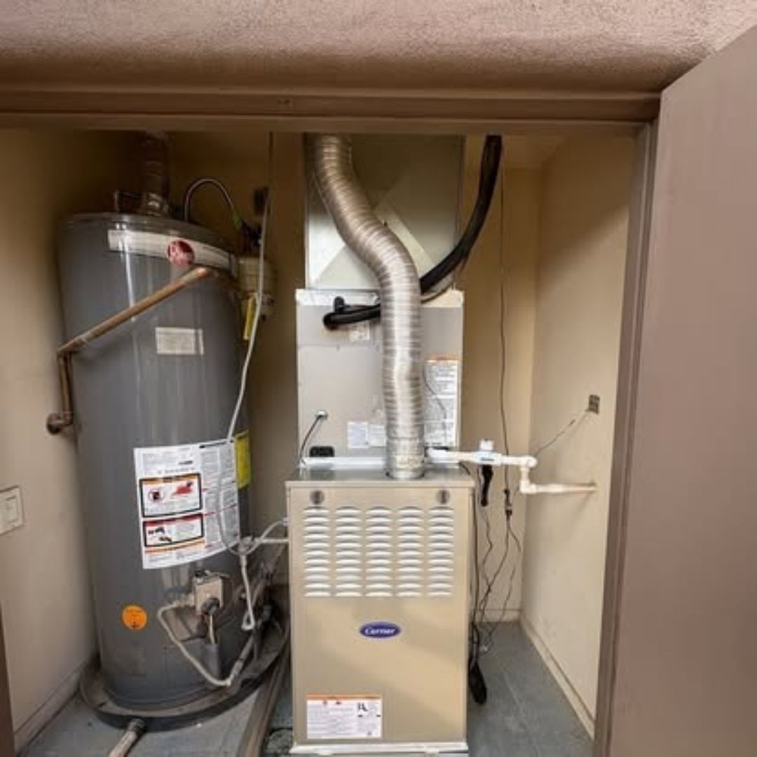 HVAC closet with water heater and furnace 
