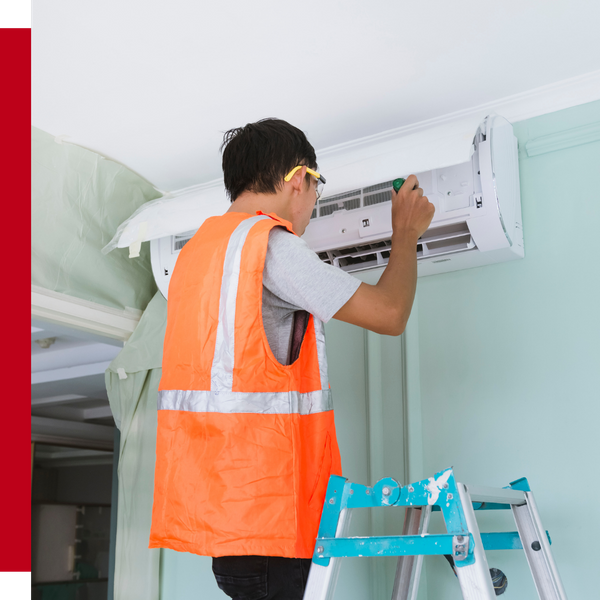 AC repairman working on ac system