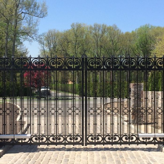 intricate modern metal gate at front of drive