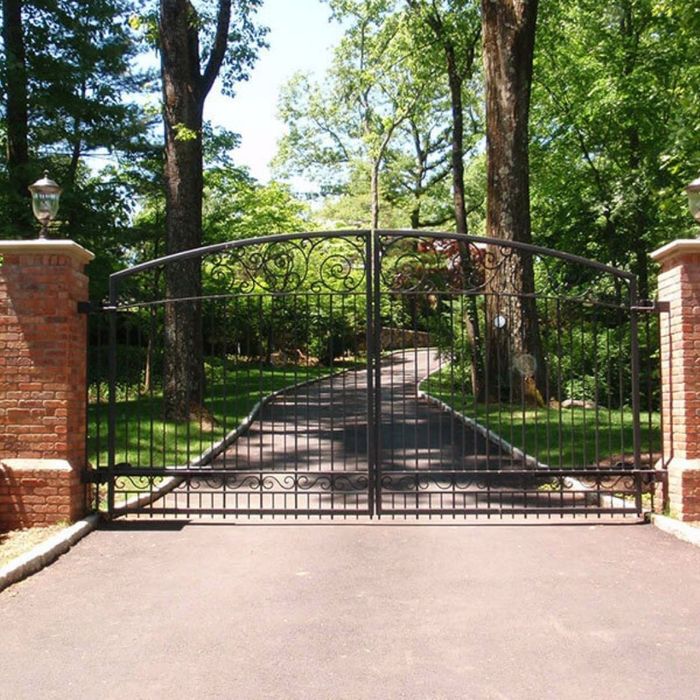 a black iron gate with a swirl design Why Choosing a Local Gate Contractor Matters for Your Next Project (4).jpg