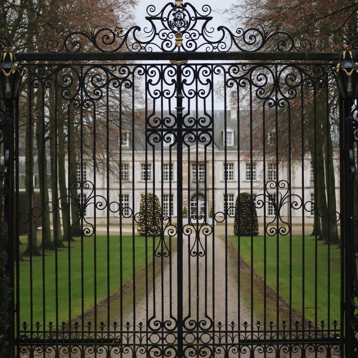 elaborate gate in front of mansion