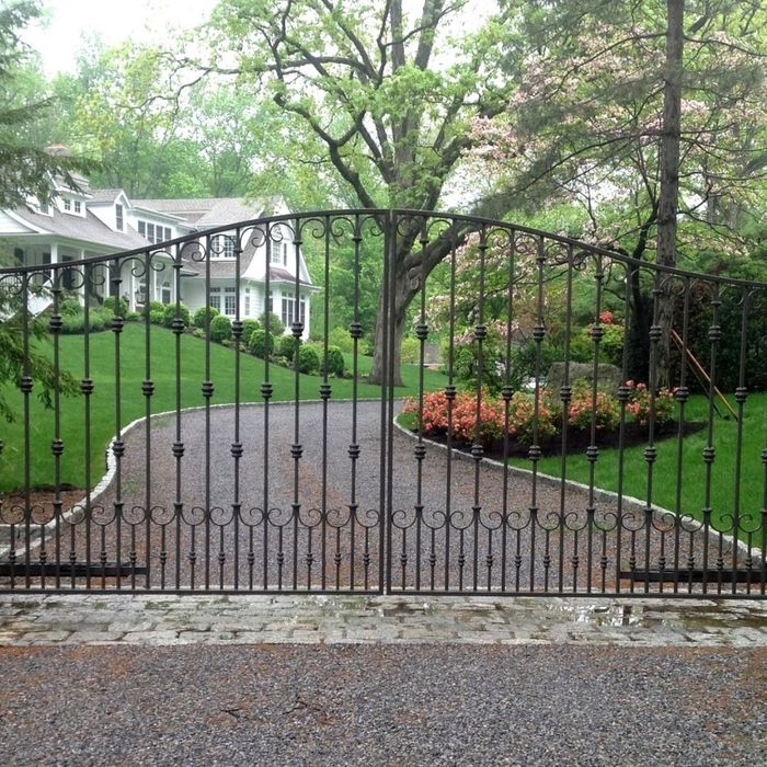 elegant metal gate in front of long driveway