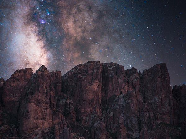 rock formation with stars behind it