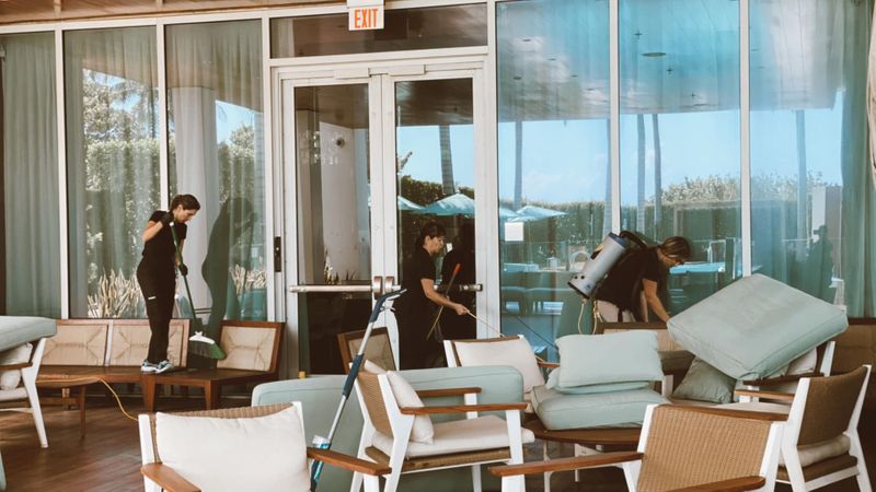 Image of people cleaning a hotel pool area