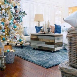 a wooden floored living room decorated for Christmas
