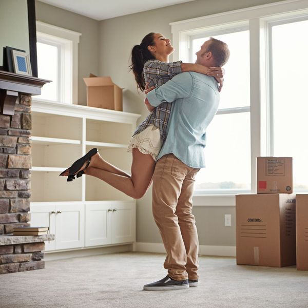 a husband and wife excited moving into a new home