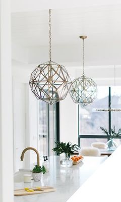 Geometric pendant lights over a kitchen island