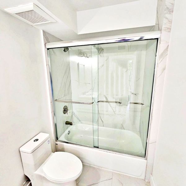a shower with marble walls