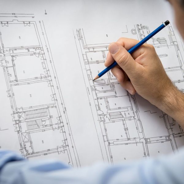 a person working on house blueprints