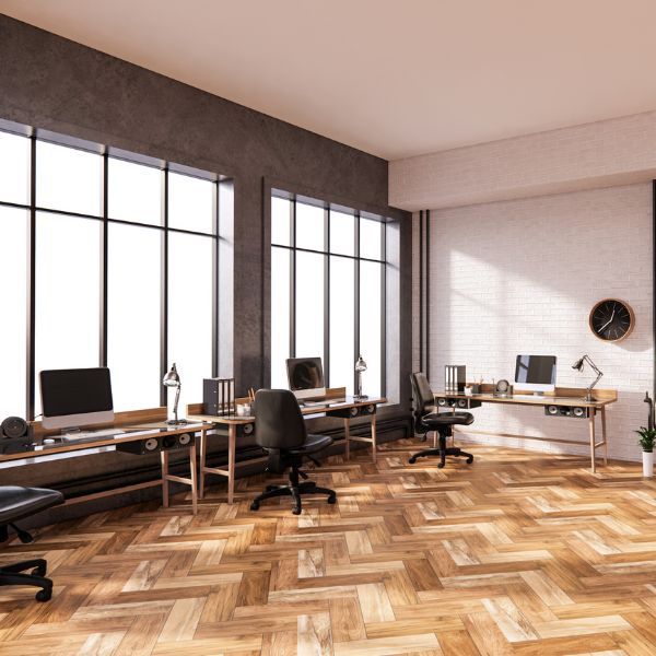 an office space with hardwood floors and a lot of windows