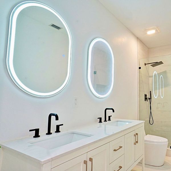 a bathroom with lights around the mirrors