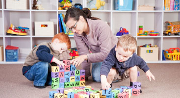 teacher and children playing with blocks