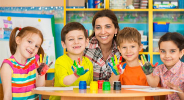 kids and teacher playing with hand paint