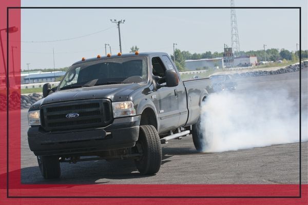 Truck moving quickly with smokey tires