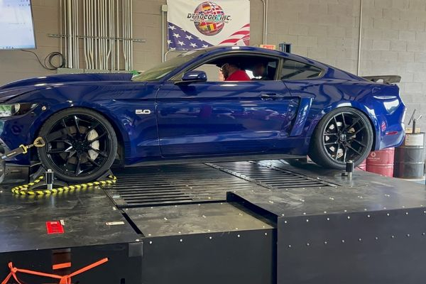 Blue car with tech inside doing dyno testing Blue car with tech inside doing dyno testing