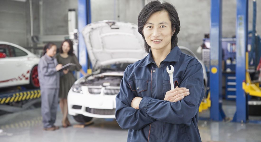 technician standing in auto shop with arms crossed CMPro blog image 1.jpg