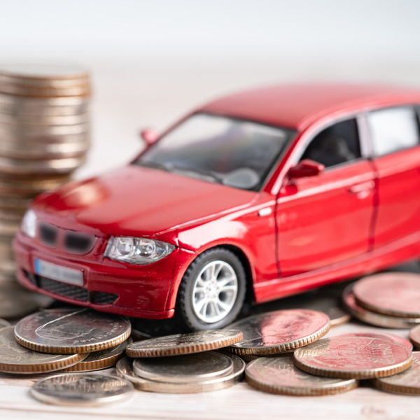 red toy car sitting on money