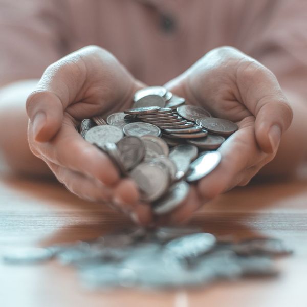 person holding coins