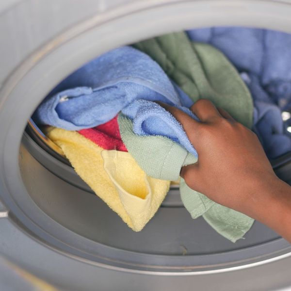 loading towels into a laundry machine