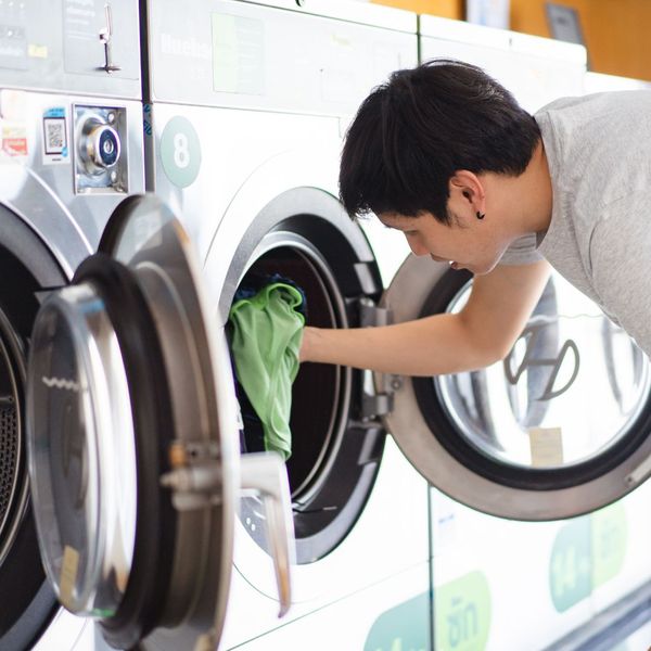 man pulling out clean laundry