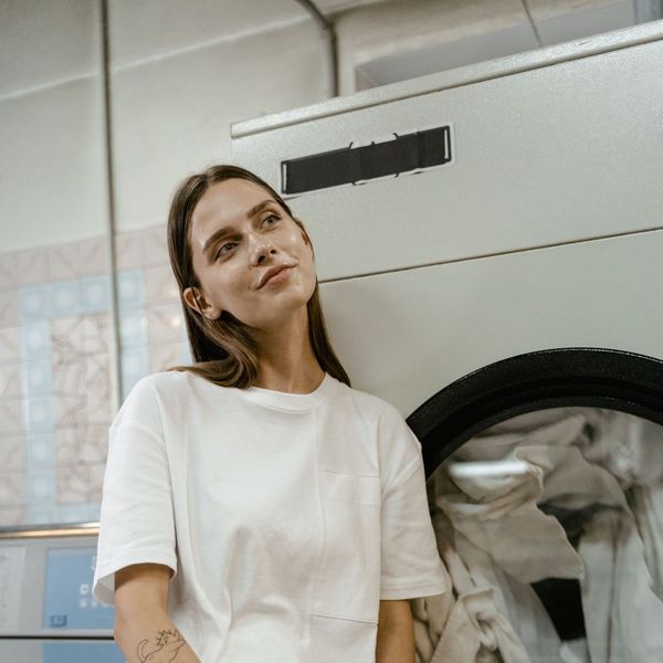 woman waiting for laundry to be done