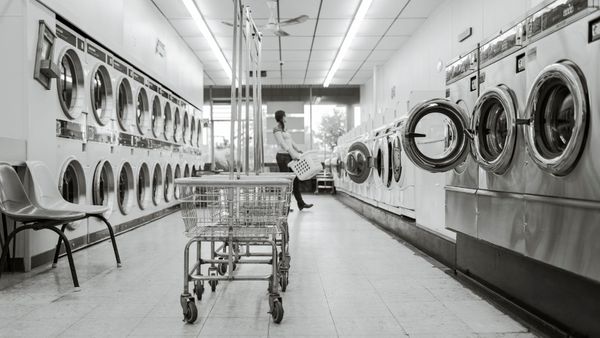 inside of a clean local laundromat with rows of coin operated laundry machines