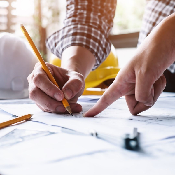 general contractors working on blueprints on a job site
