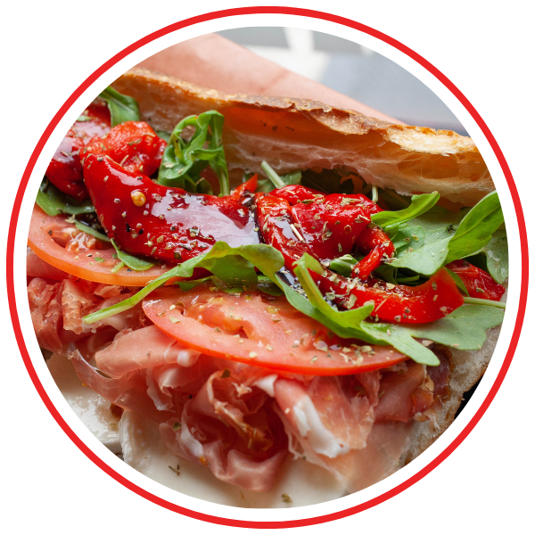 Italian sandwich with arugula, red pepper, toomato, meat, and cheese