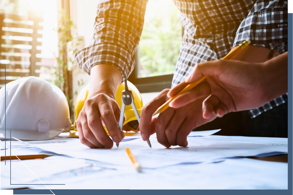 two contractors working on blueprints