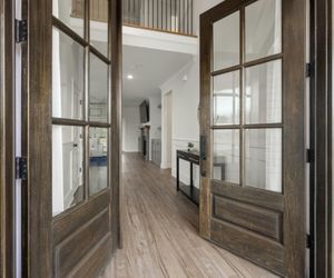 dark wooden french doors opening into a home