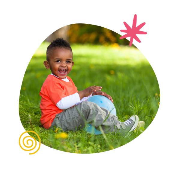 A toddler palying outside.