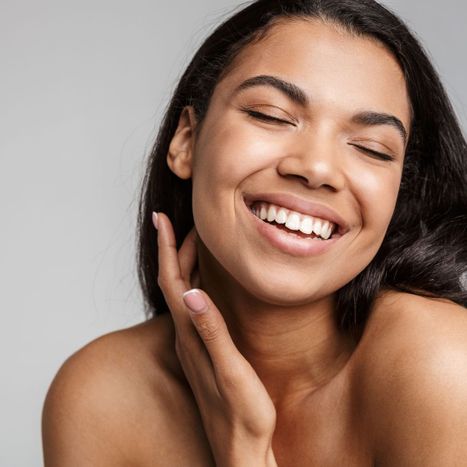 A girl smiling with glowing skin
