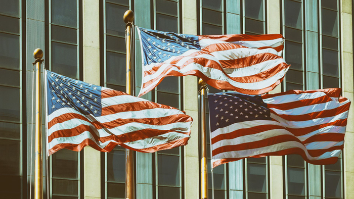 three american flags in front of building