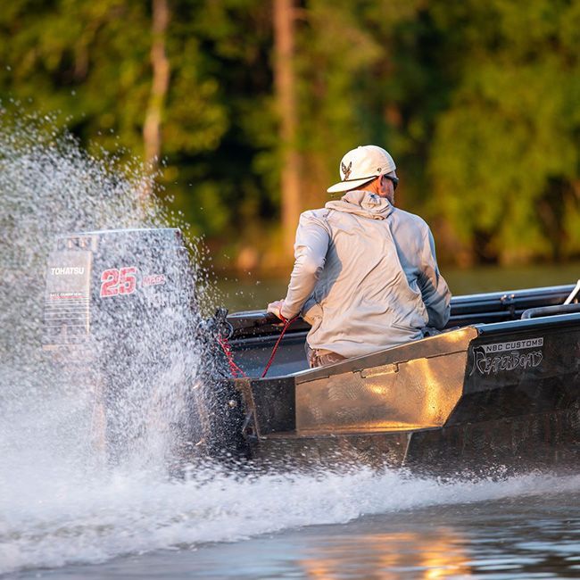 man with backwards hat on boat