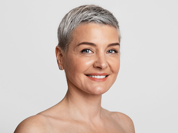 An older woman smiling after receiving a PRP treatment