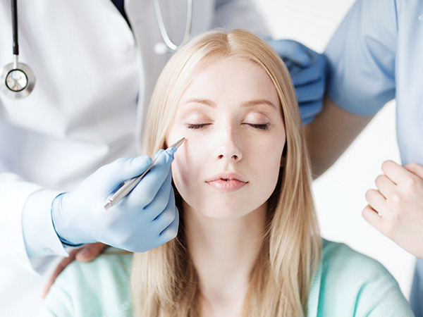 A woman getting a cosmetic surgery consultation