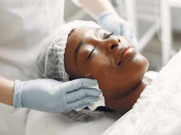 A woman relaxing while getting a facial