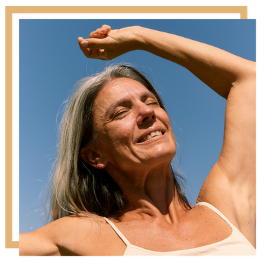 woman in the sun with her arm above her head