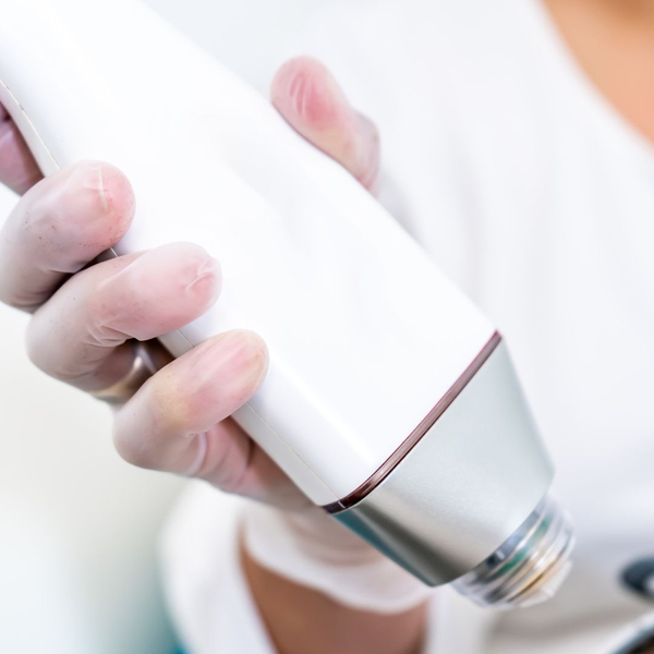 close up of someone holding a microdermabrasion tool