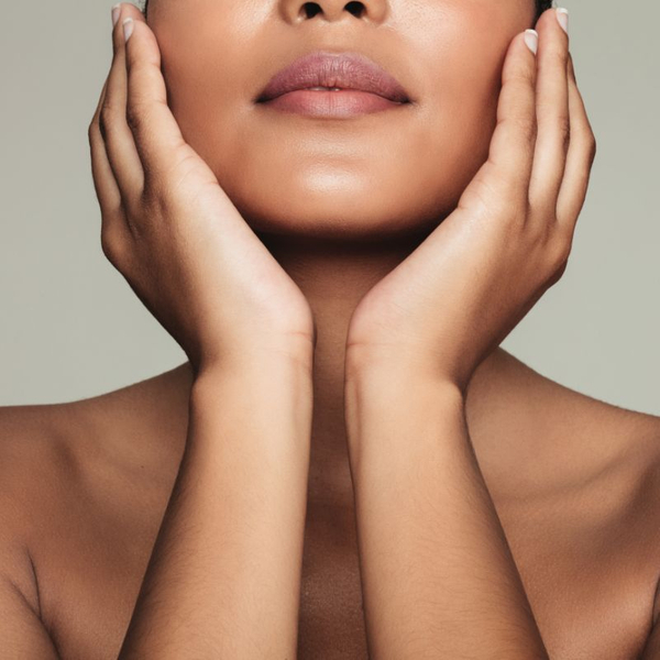 close up of woman holding face in her hands with smooth skin