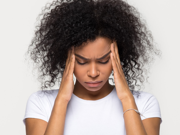 A young woman suffering from a migraine
