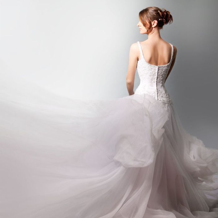 woman wearing a ballgown with her back turned towards the camera